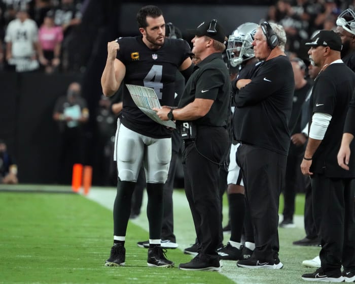 Las Vegas Raiders quarterback Derek Carr (4) speaks with head coach Jon Gruden